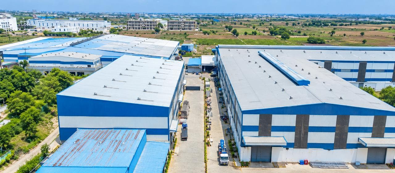 Aerial view of the Indus Appliances production blocks in Bahadurgarh, with the main factory buildings either side of the internal road