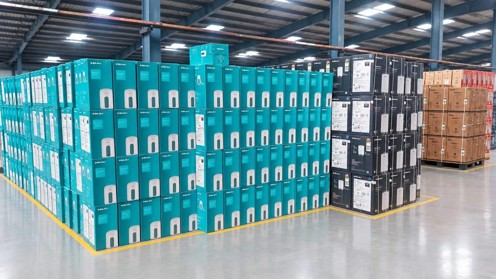 Stacks of boxed instant and storage water heaters in marked bays on the Bahadurgarh dispatch floor